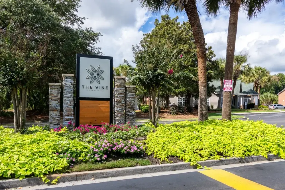 main entrance monument sign the vine at bermuda run apartments near gsu